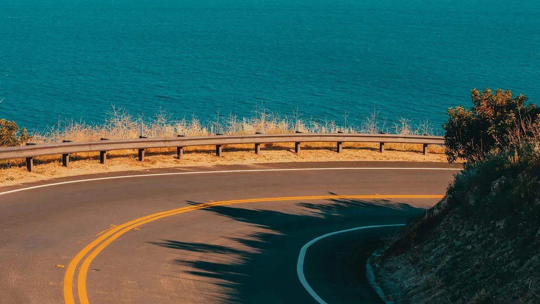 A curved coastal road above the ocean